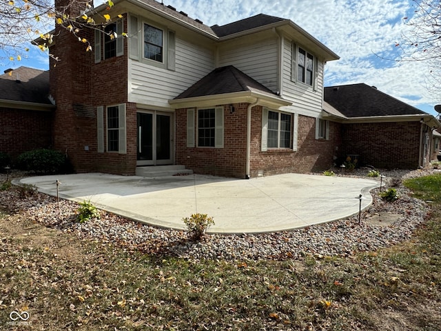 back of property with a patio