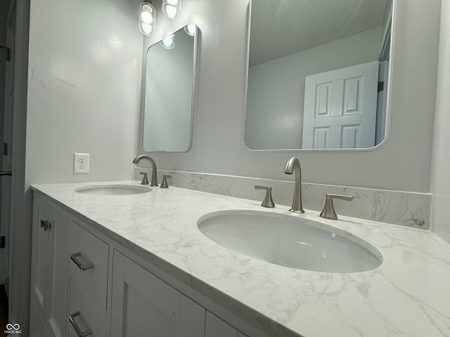 bathroom with vanity and a textured ceiling