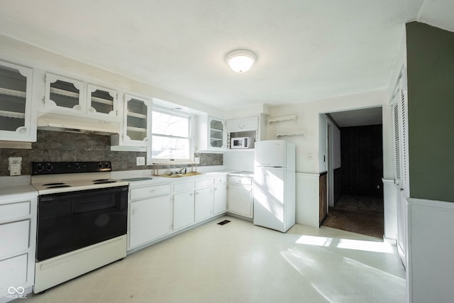 kitchen with white cabinetry, white appliances, sink, and backsplash