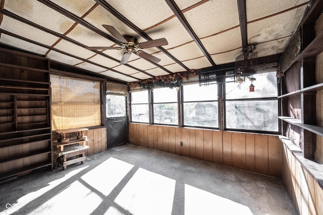 unfurnished sunroom with ceiling fan