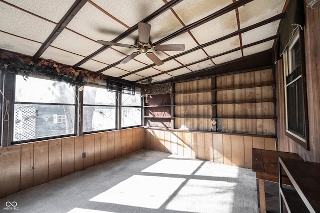 unfurnished sunroom featuring ceiling fan