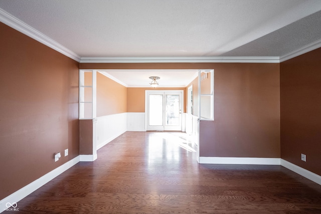 unfurnished room with a textured ceiling, dark hardwood / wood-style floors, and crown molding