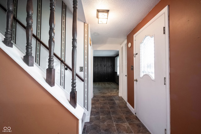 corridor featuring a textured ceiling