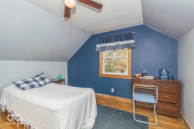 bedroom with lofted ceiling, hardwood / wood-style flooring, and ceiling fan