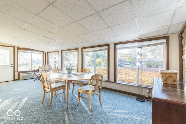 sunroom with a drop ceiling and a wealth of natural light