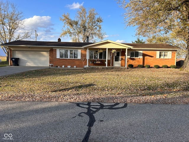 ranch-style house featuring a garage, a porch, and a front lawn