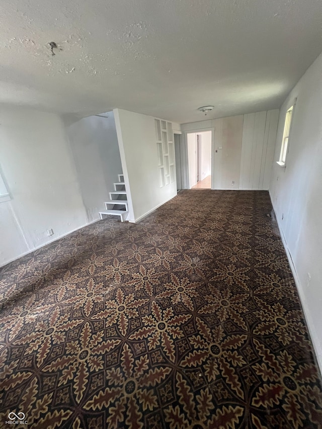 unfurnished room featuring a textured ceiling