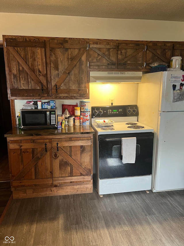 kitchen featuring white appliances and dark hardwood / wood-style floors