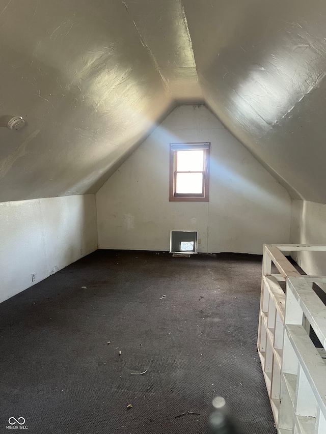 bonus room featuring lofted ceiling and carpet