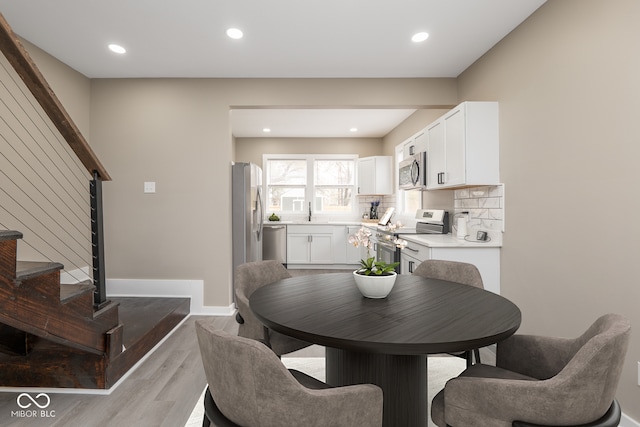 dining room with sink and light hardwood / wood-style floors