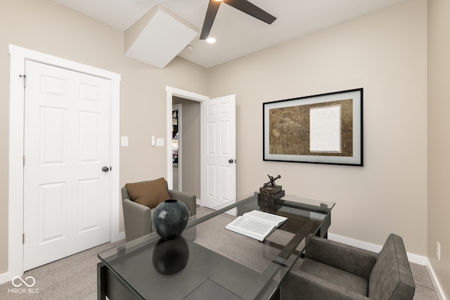 carpeted home office featuring ceiling fan