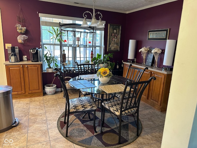 tiled dining area with a textured ceiling, an inviting chandelier, and crown molding