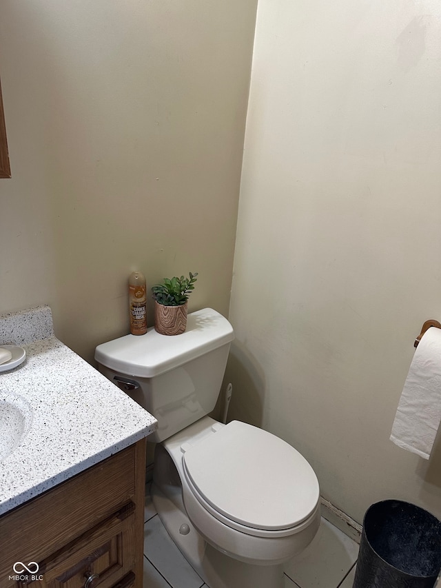 bathroom featuring toilet, vanity, and tile patterned floors