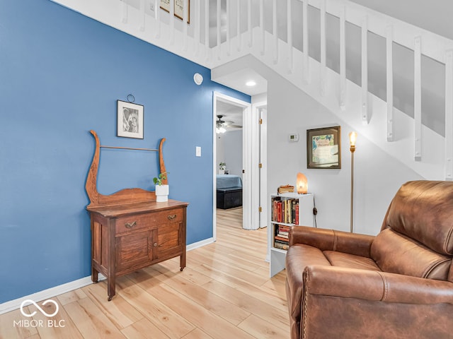 sitting room featuring light hardwood / wood-style flooring and ceiling fan