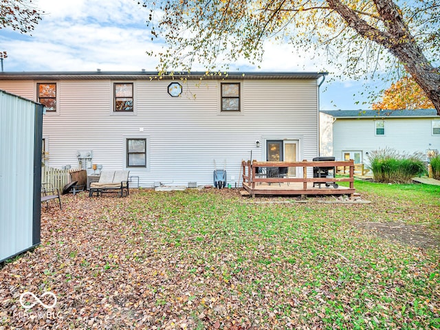 rear view of property with a lawn and a deck