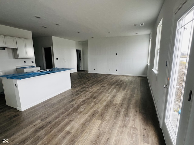 kitchen with white cabinets, a healthy amount of sunlight, and hardwood / wood-style flooring