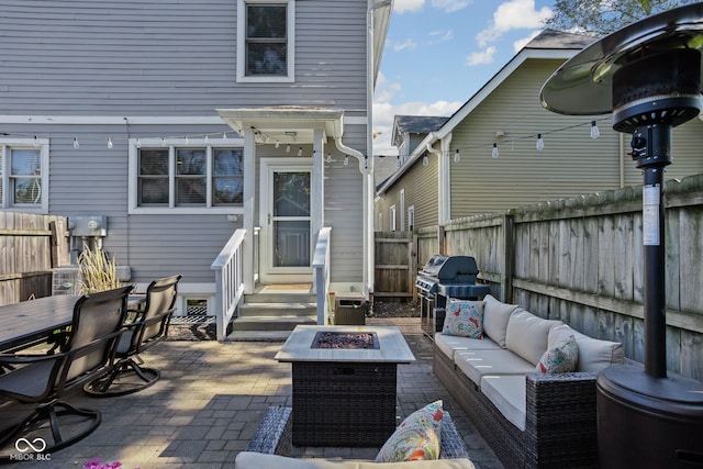 view of patio / terrace featuring grilling area and an outdoor living space with a fire pit