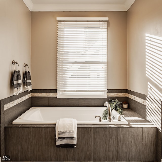 bathroom featuring tiled tub and ornamental molding