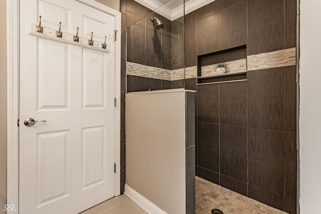 bathroom featuring tile patterned floors, ornamental molding, and tiled shower