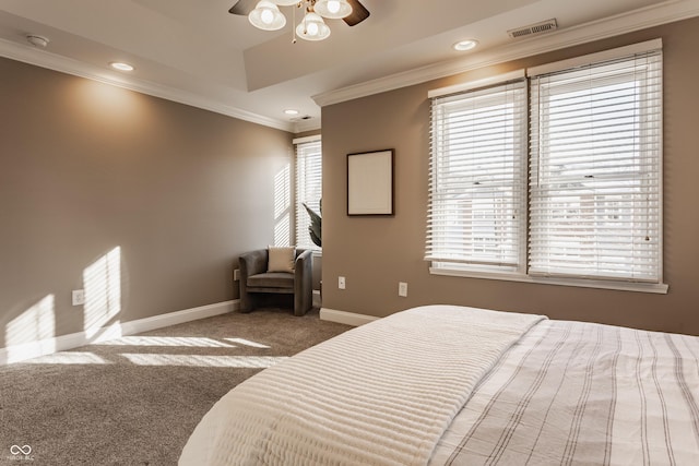 carpeted bedroom with ceiling fan and ornamental molding