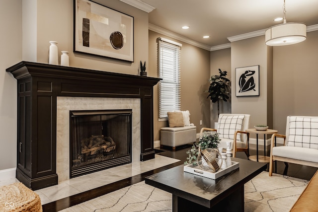 living area with a fireplace, light hardwood / wood-style floors, and ornamental molding