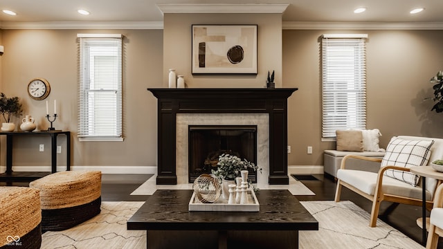 sitting room featuring crown molding, a fireplace, and wood-type flooring