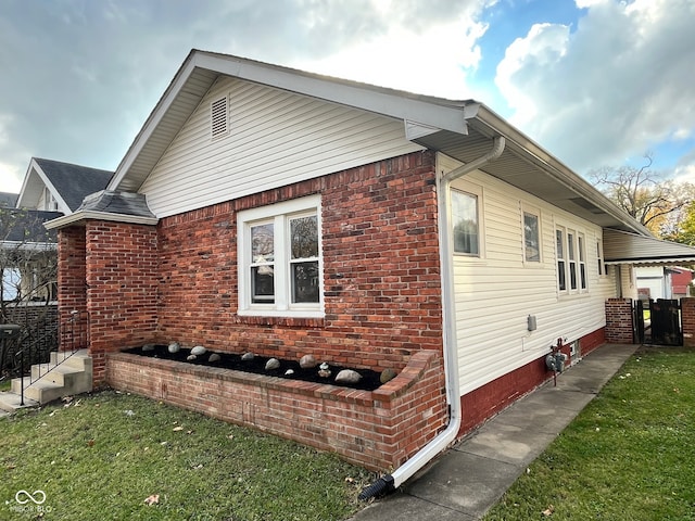 view of side of home featuring a yard