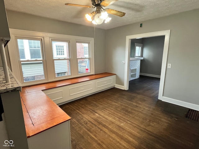 interior space featuring dark hardwood / wood-style flooring, a wealth of natural light, and ceiling fan