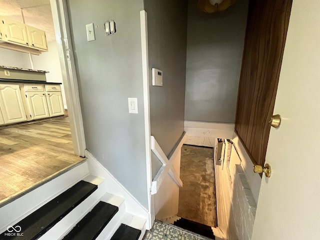 stairway featuring hardwood / wood-style floors