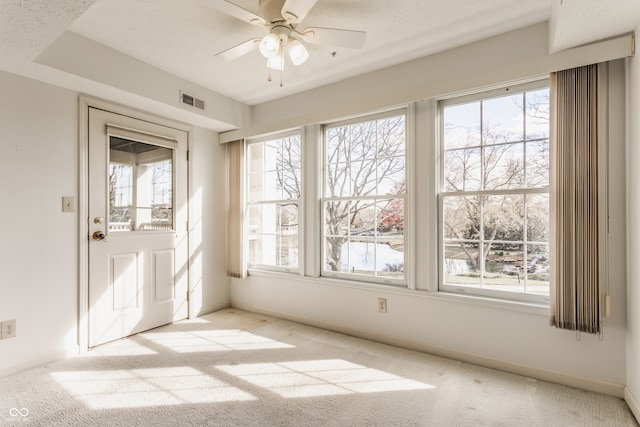 carpeted empty room with a textured ceiling and ceiling fan