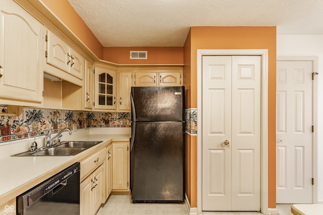 kitchen featuring black appliances, sink, and a textured ceiling