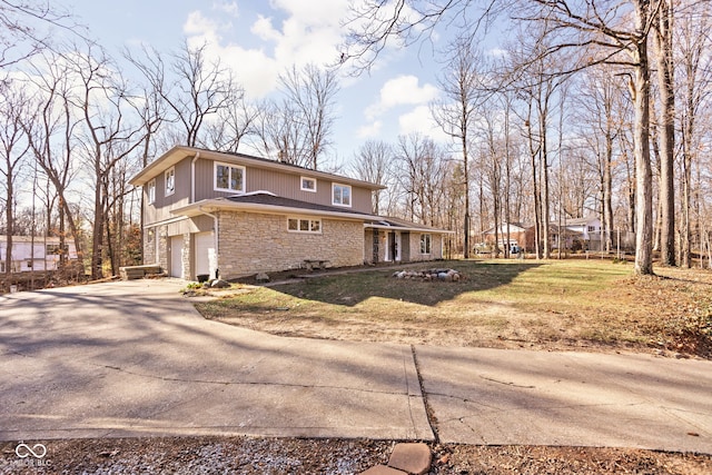 view of side of home with a yard and a garage