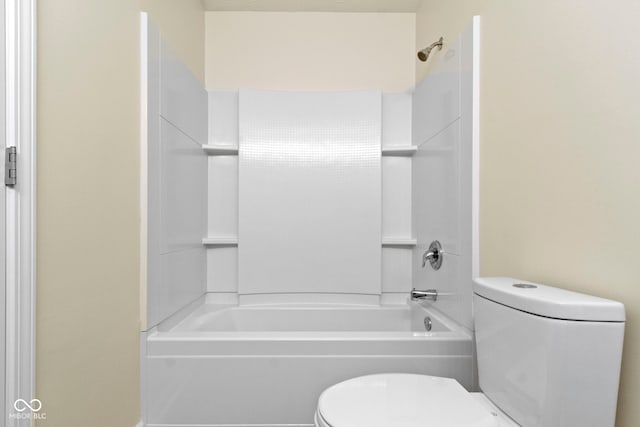 bathroom with washtub / shower combination and toilet