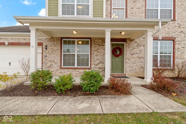 property entrance with a porch and a garage