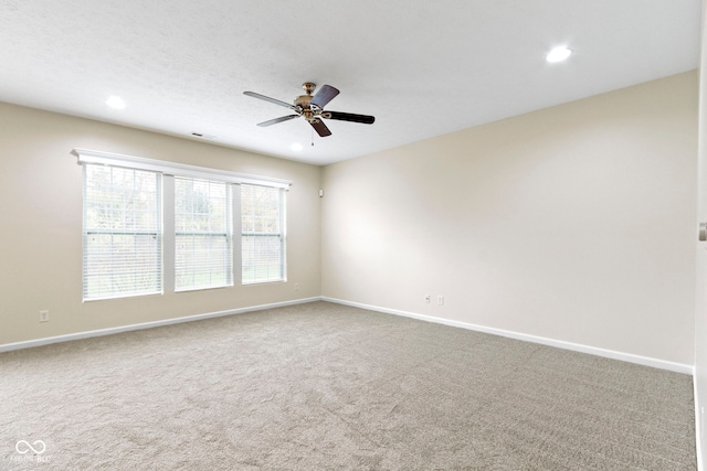 carpeted empty room with ceiling fan