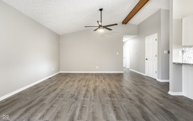 unfurnished living room featuring a textured ceiling, dark hardwood / wood-style flooring, lofted ceiling with beams, and ceiling fan