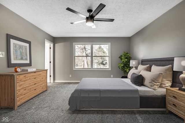 bedroom with a textured ceiling, dark carpet, and ceiling fan