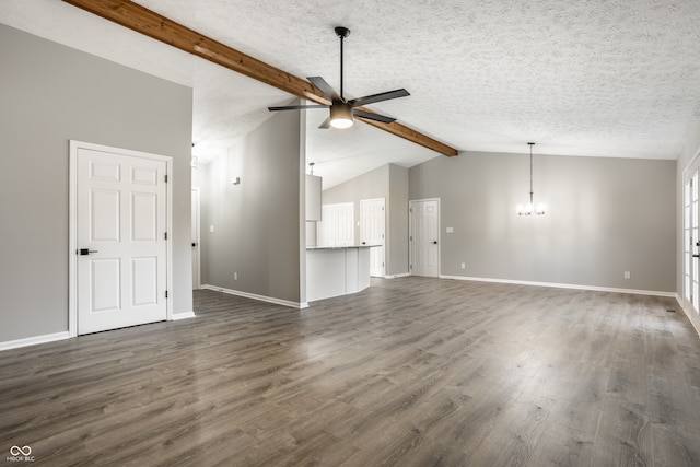 unfurnished living room with ceiling fan with notable chandelier, vaulted ceiling with beams, dark hardwood / wood-style flooring, and a textured ceiling