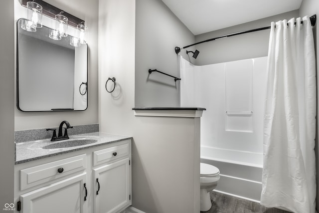 full bathroom with hardwood / wood-style floors, vanity, toilet, and shower / bathtub combination with curtain