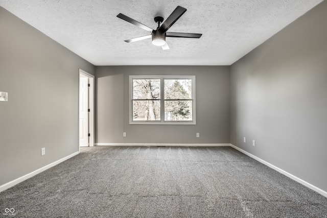 carpeted empty room with ceiling fan and a textured ceiling