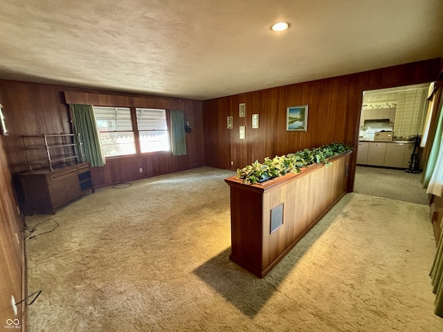 interior space with wooden walls and light carpet