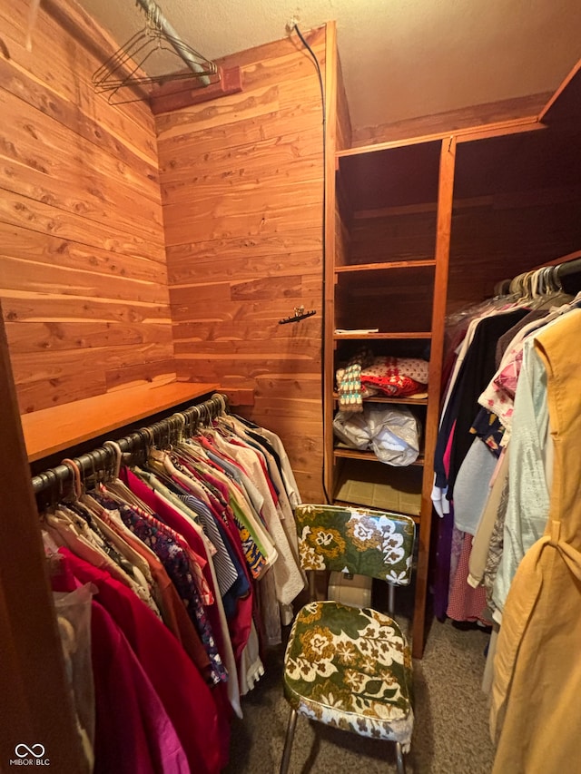 walk in closet featuring carpet flooring