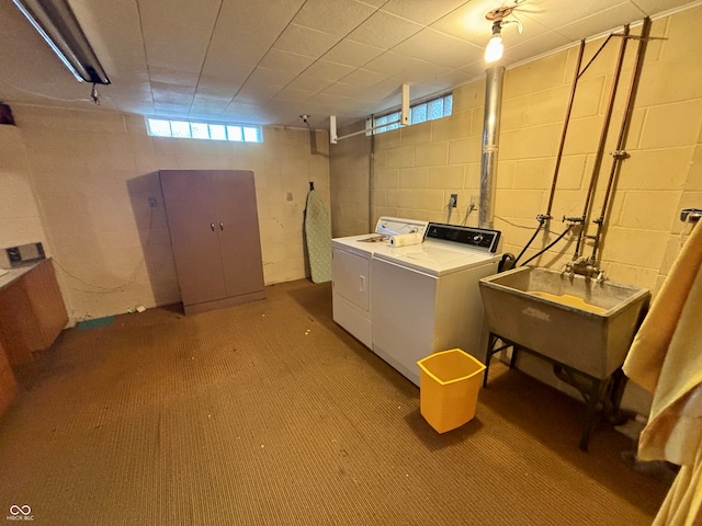 laundry area with washing machine and dryer, sink, and carpet floors