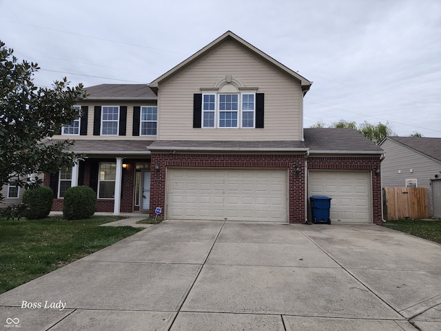 front facade with a garage and a front lawn