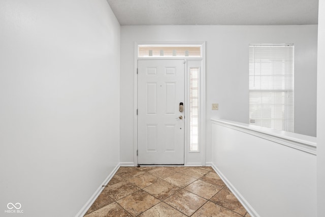 foyer featuring a textured ceiling