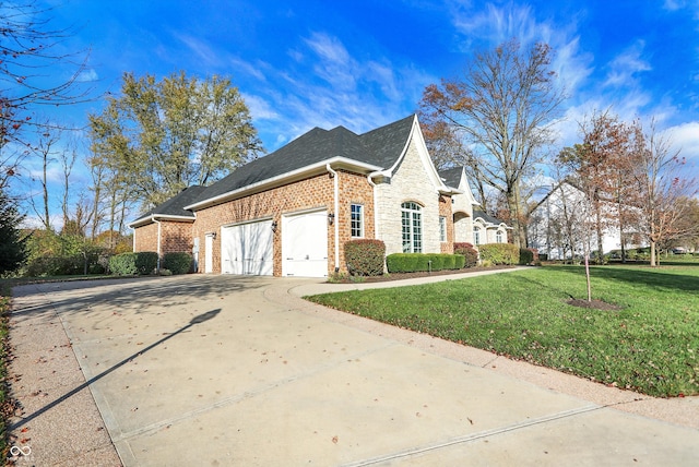 view of side of property featuring a garage and a lawn