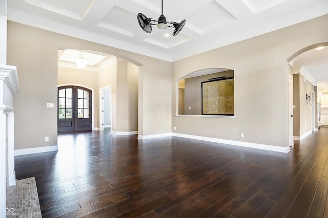 unfurnished living room featuring ornamental molding, an inviting chandelier, dark hardwood / wood-style flooring, coffered ceiling, and french doors