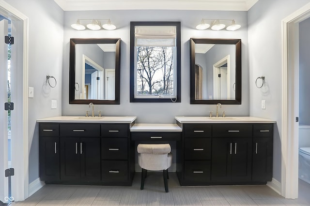 bathroom featuring crown molding, vanity, and toilet