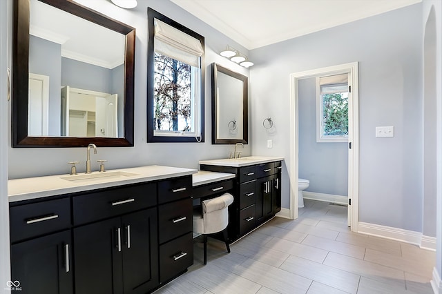 bathroom with vanity, toilet, and ornamental molding