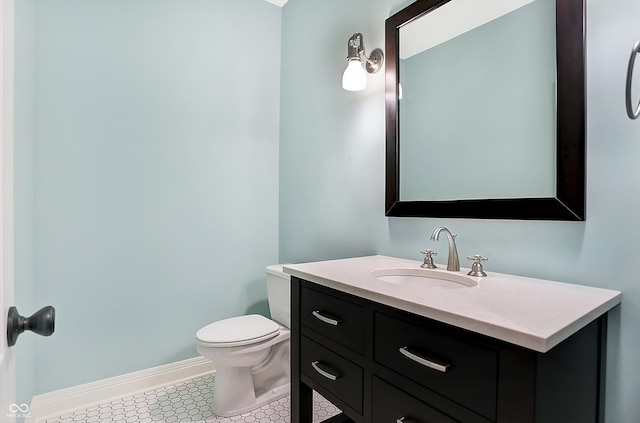 bathroom with tile patterned flooring, vanity, and toilet